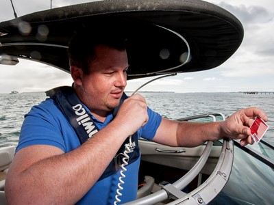Man using radio on boat