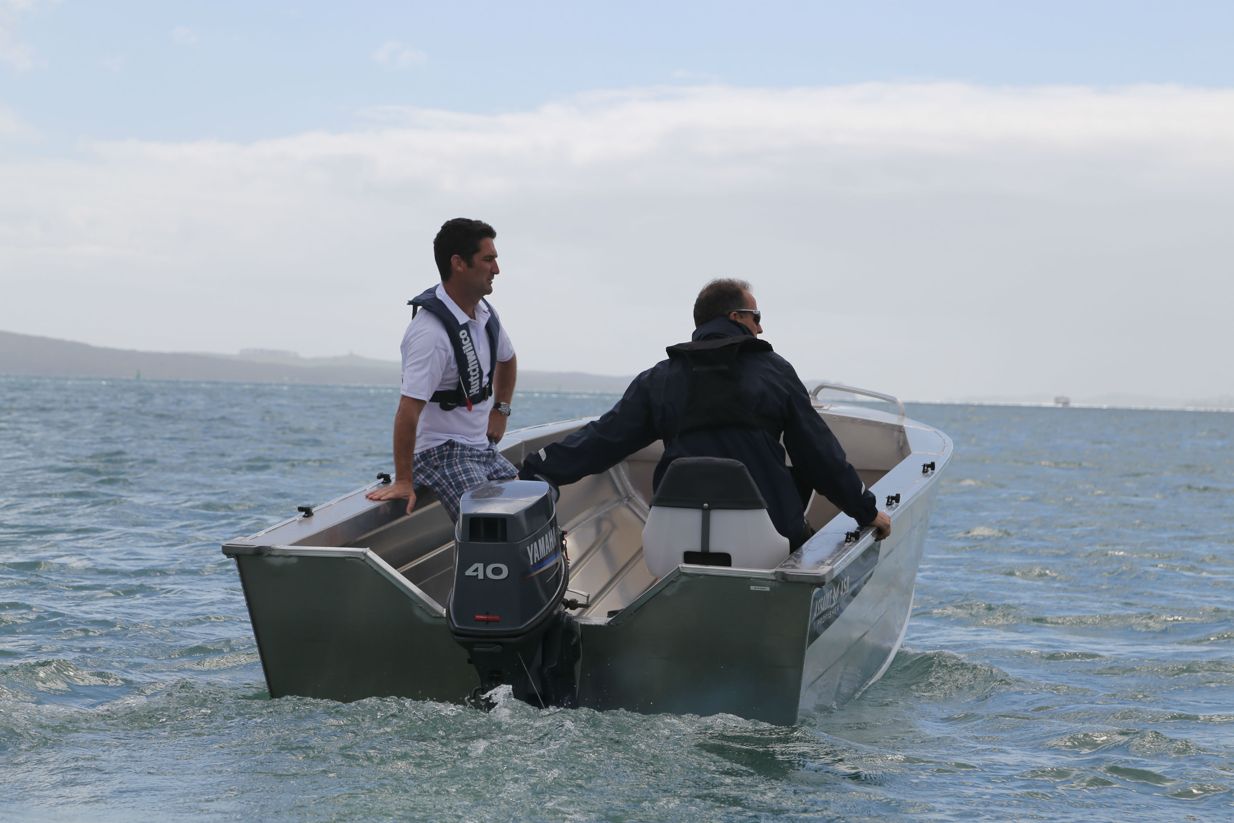 people with lifejackets in a boat
